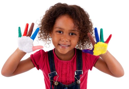 Little African Asian girl with hands painted in colorful paints